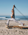 woman wearing vuori doing pilates